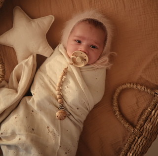 Mushie Organic Cotton Muslin Swaddle Blanket in assorted patterns