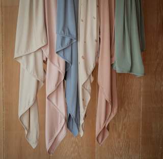 Mushie Stretchy Swaddle in dried thyme and natural