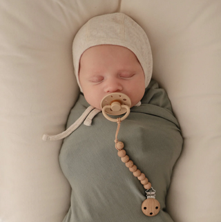 Mushie Stretchy Swaddle in dried thyme and natural